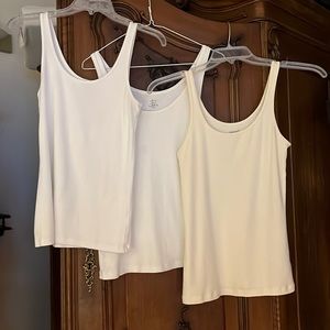 Woman’s size medium 4 pack ( 2 white, 1 cream, 1 black) tank tops